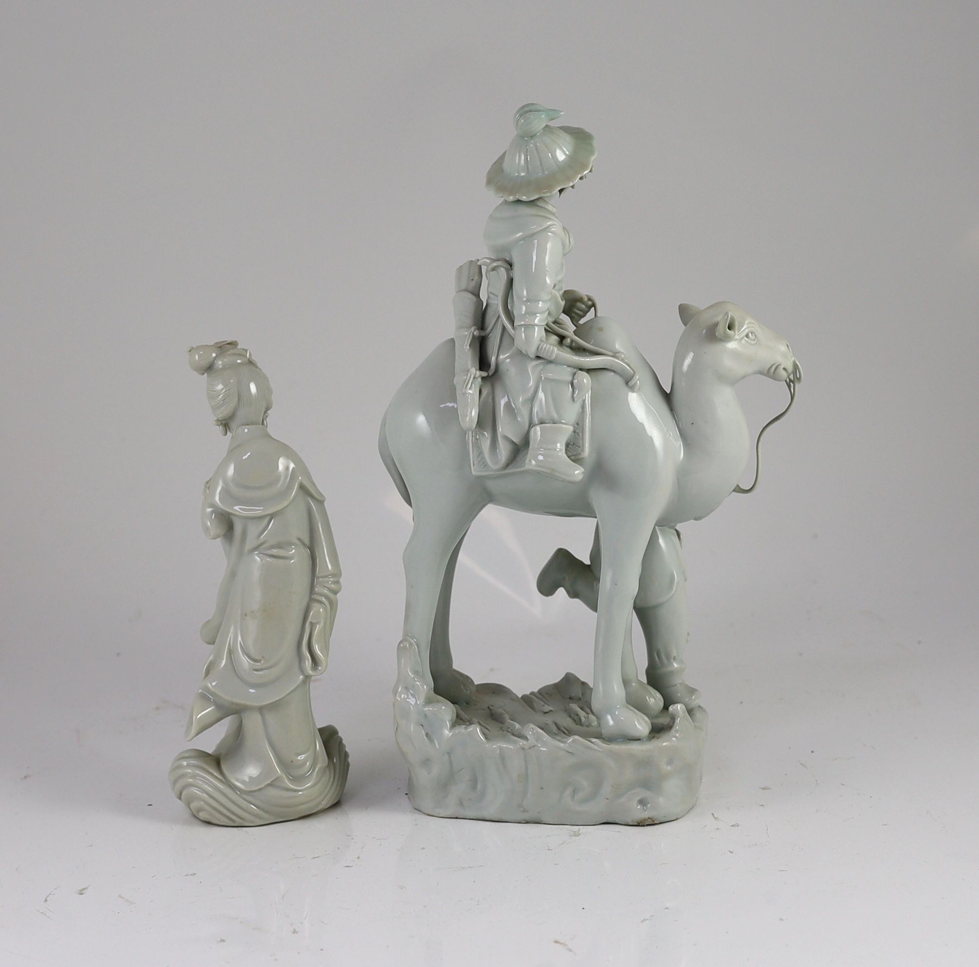 A Chinese blanc-de-chine group of Hua Mulan being led upon a camel, and a similar figure of Guanyin, Dehua kilns, both Republic period, Tallest 31 cm